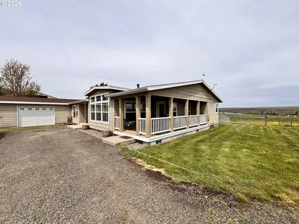 a front view of a house with a garden and yard