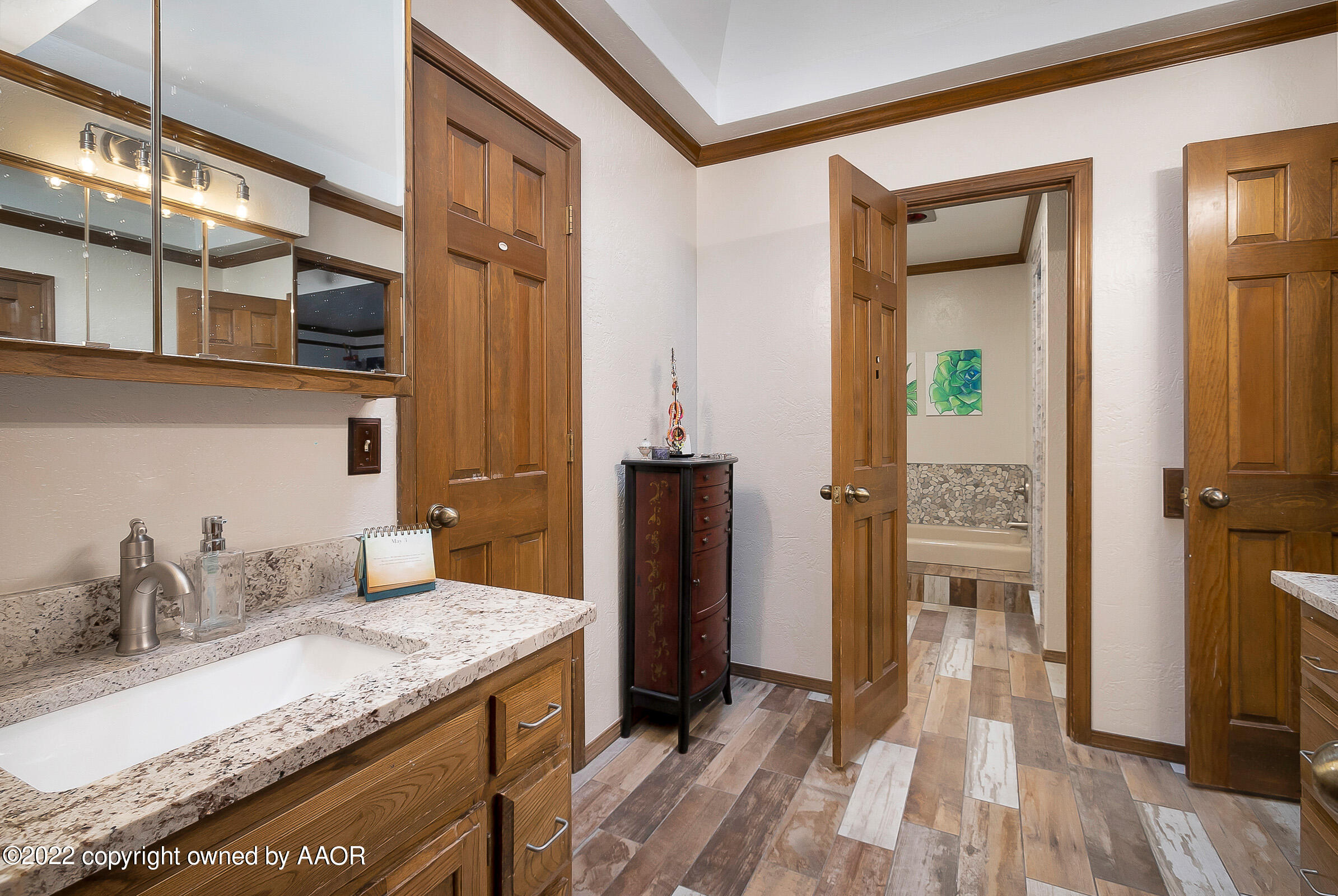 6600 Stoneham Drive Amarillo, TX 79109 - Photo 27 of 43 a bathroom with a granite countertop sink and a mirror
