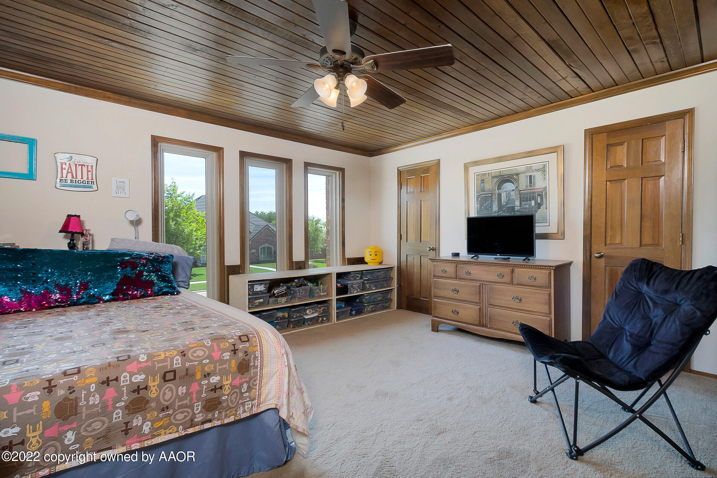 6600 Stoneham Drive Amarillo, TX 79109 - Photo 33 of 43 a bedroom with furniture and a flat screen tv