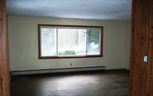 847 Patriots Road Templeton, MA 01468 - Photo 4 of 10 a view of an empty room with wooden floor and a window