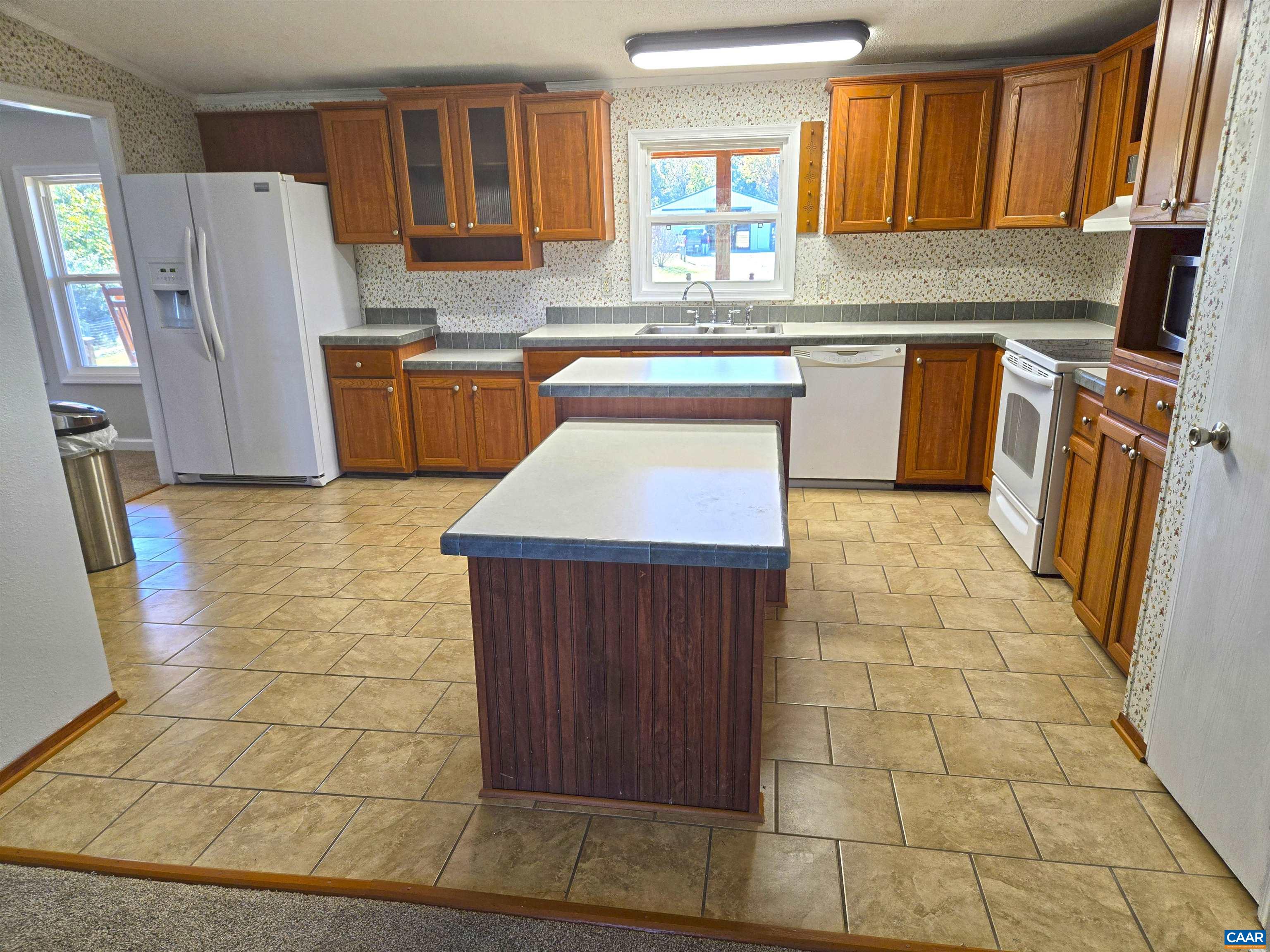 3691 Meherrin Road Meherrin, VA 23954 - Photo 11 of 75 a kitchen with stainless steel appliances granite countertop a stove refrigerator sink and cabinets
