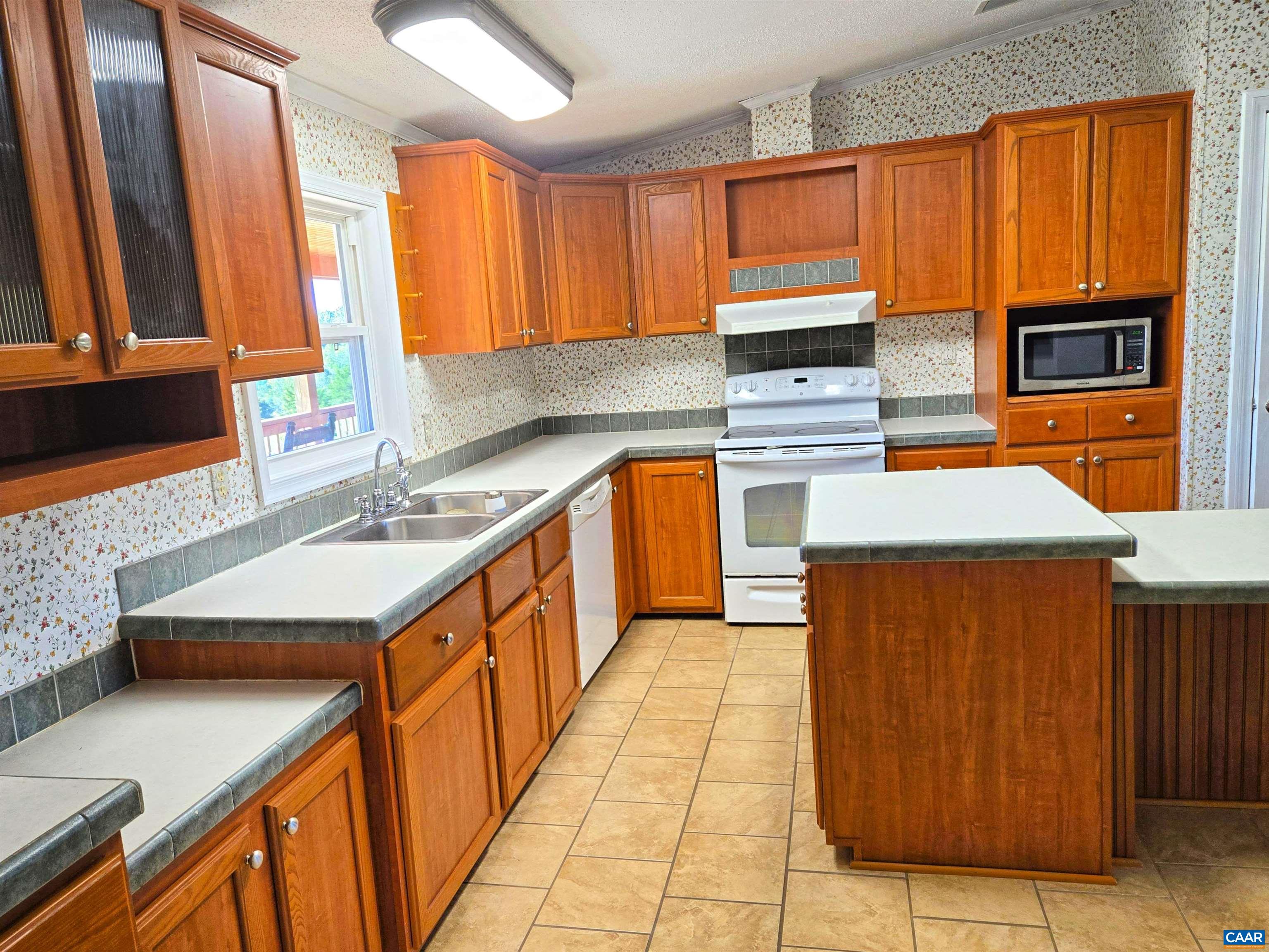 3691 Meherrin Road Meherrin, VA 23954 - Photo 12 of 75 a kitchen with stainless steel appliances kitchen island granite countertop a sink stove and cabinets