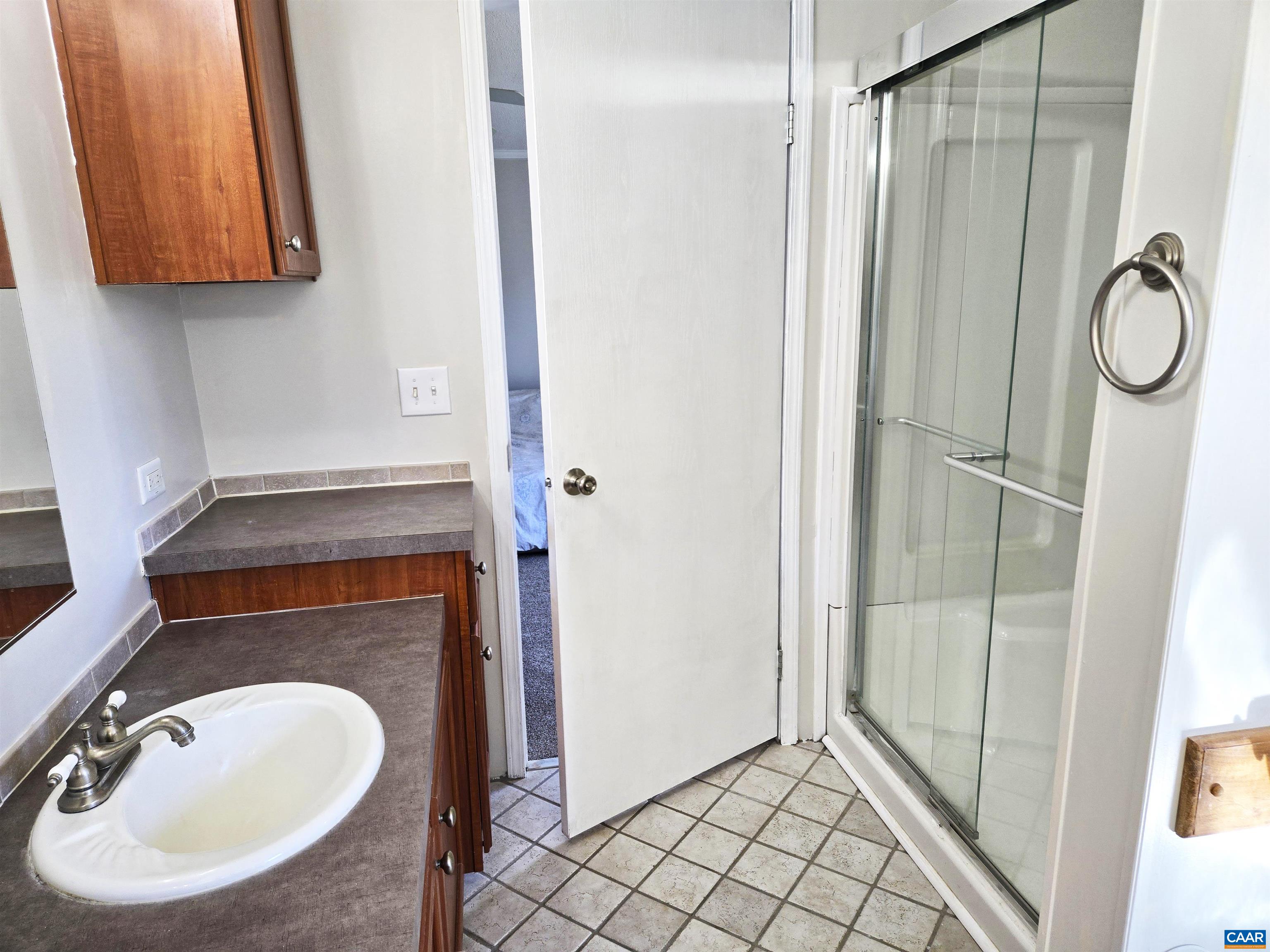 3691 Meherrin Road Meherrin, VA 23954 - Photo 16 of 75 a bathroom with a sink a mirror and a shower
