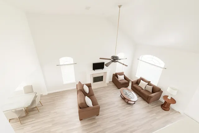 a living room with furniture and wooden floor