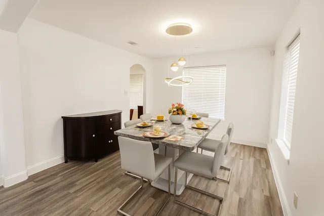 a view of a dining room with furniture and wooden floor