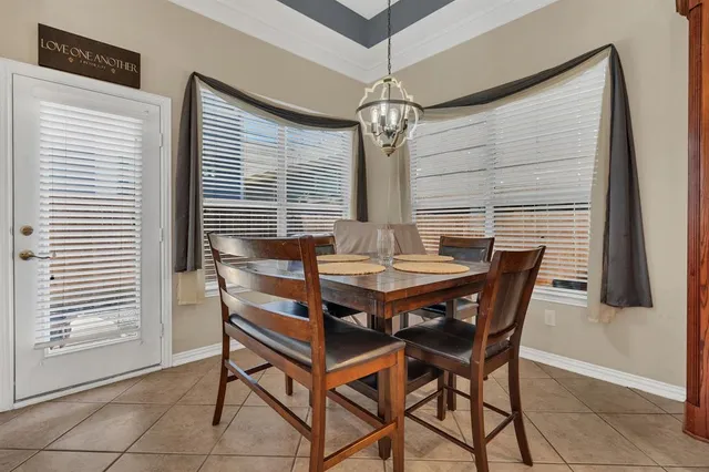 a view of a dining room with furniture and window
