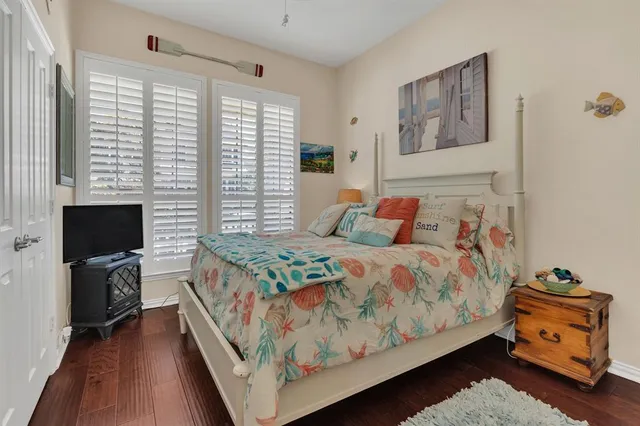 a bedroom with a bed and a tv