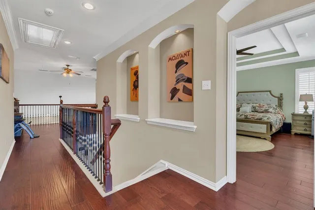 a view of a hallway with workspace and wooden floor