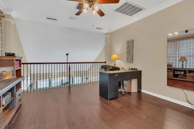 a view of a workspace with furniture and wooden floor