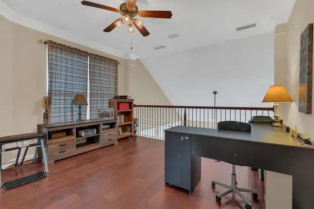a view of a workspace with furniture and a window