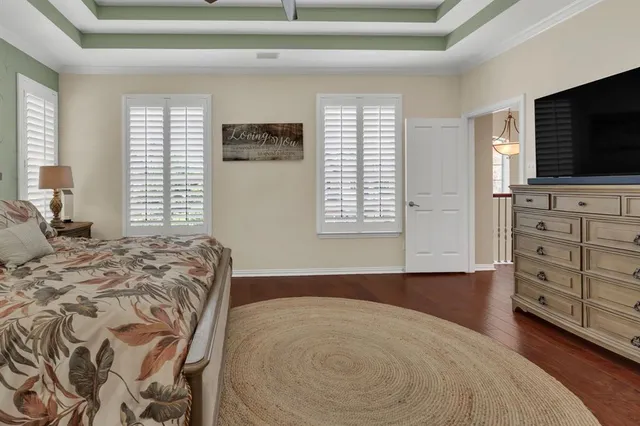 a bed room with a bed a television and a window