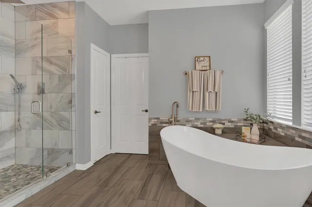 a spacious bathroom with a bathtub and shower