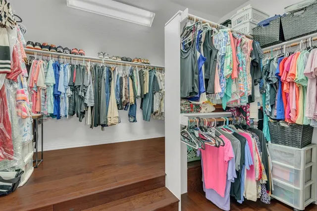 a view of walk in closet with clothes