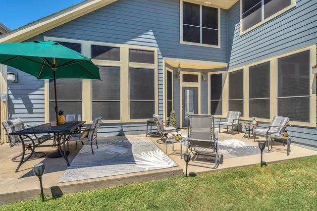 a patio with a table and chairs