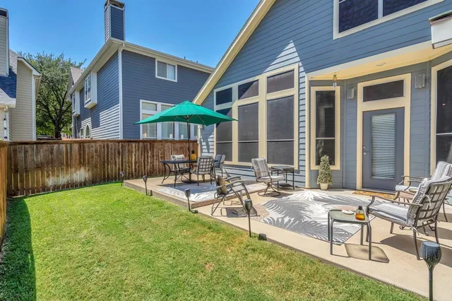 a view of a house with backyard and sitting area