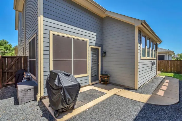 a view of house with backyard and outdoor seating