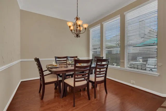 a view of a dining room with furniture wooden floor and chandelier
