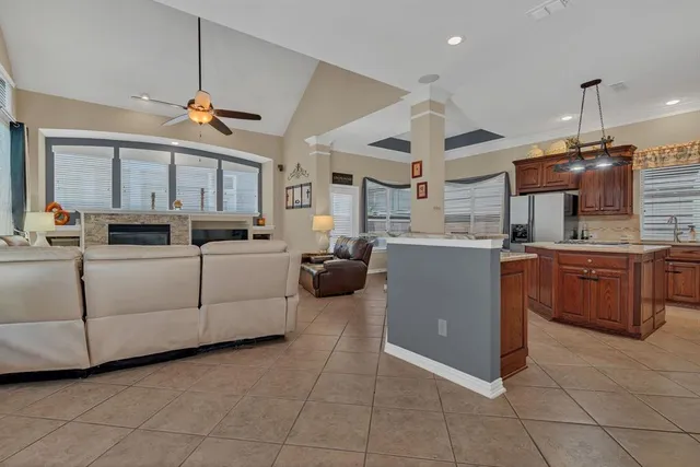 a kitchen with cabinets and chairs