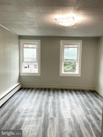 a view of an empty room and a window