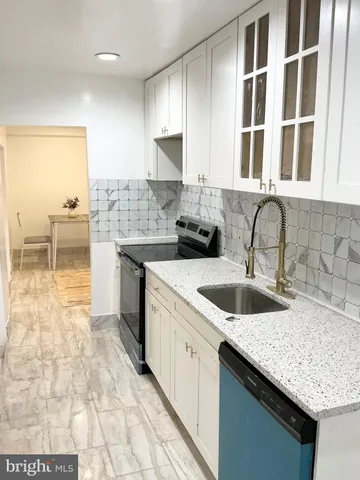 a kitchen with a sink and cabinets