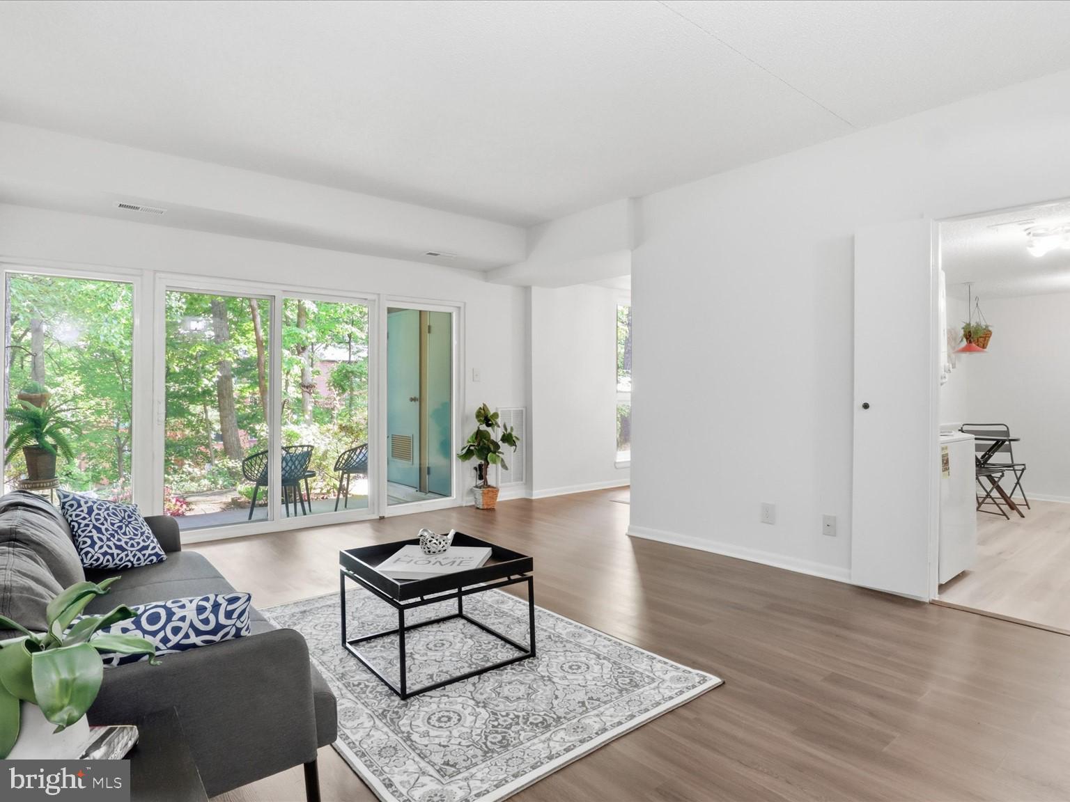 11809 Breton Court, Unit 2B Reston, VA 20191 - Photo 6 of 29 a living room with furniture and a large window