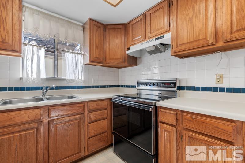 1236 Laredo Court Reno, NV 89503 - Photo 9 of 29 a kitchen with cabinets appliances a sink and a counter space