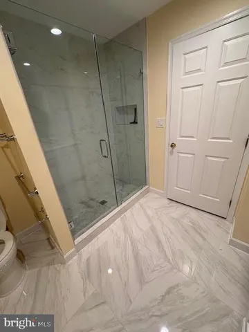 a bathroom with a shower and a glass door