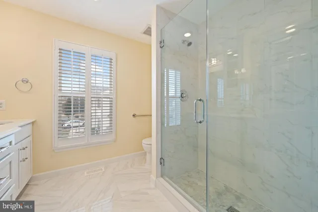 a bathroom with a shower and a sink