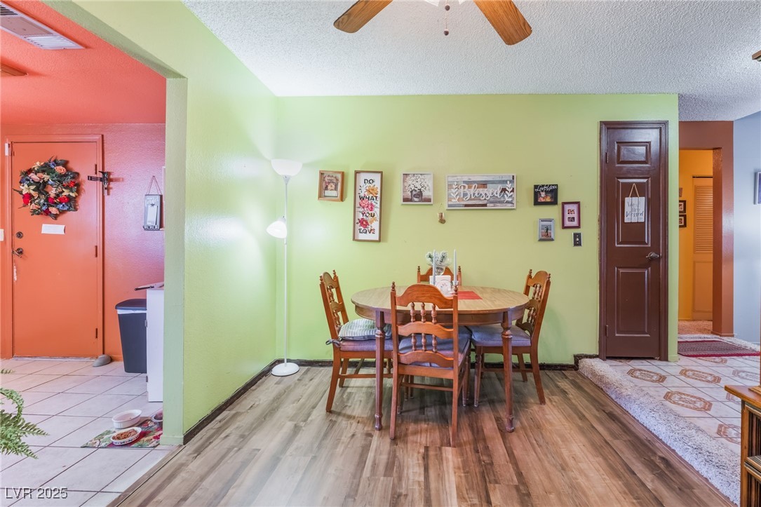 6513 Deadwood Road Las Vegas, NV 89108 - Photo 13 of 34 Dining area with a textured ceiling, wood finished floors, and a ceiling fan