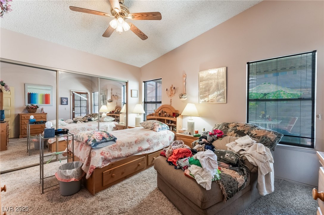 6513 Deadwood Road Las Vegas, NV 89108 - Photo 19 of 34 Bedroom featuring carpet flooring, a textured ceiling, a closet, vaulted ceiling, and a ceiling fan