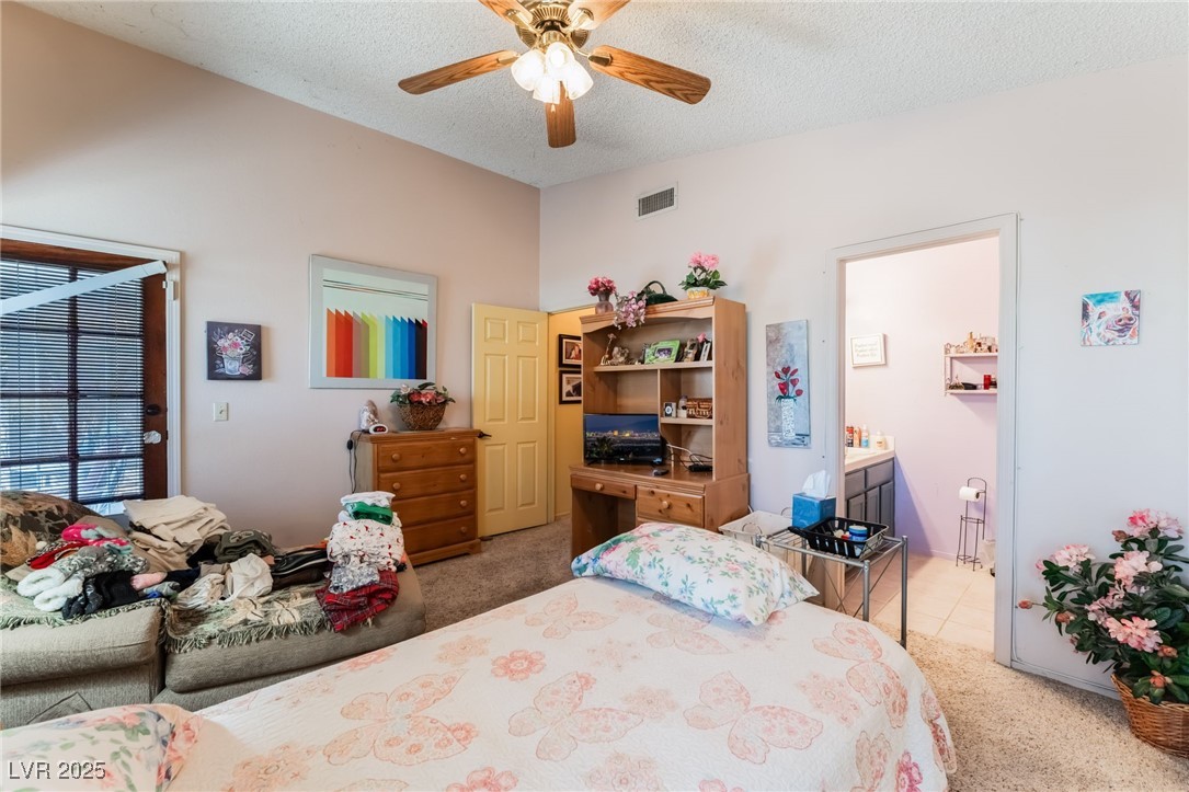6513 Deadwood Road Las Vegas, NV 89108 - Photo 21 of 34 Bedroom featuring light carpet, a textured ceiling, ceiling fan, connected bathroom, and lofted ceiling