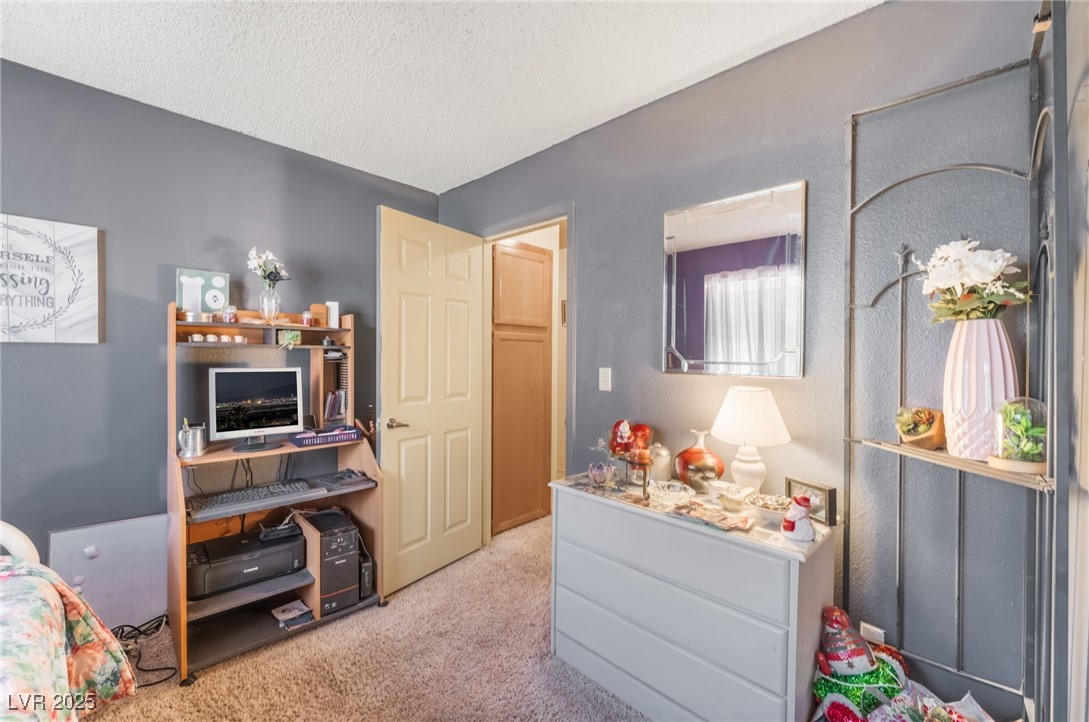 6513 Deadwood Road Las Vegas, NV 89108 - Photo 27 of 34 Bedroom with light colored carpet and a textured ceiling