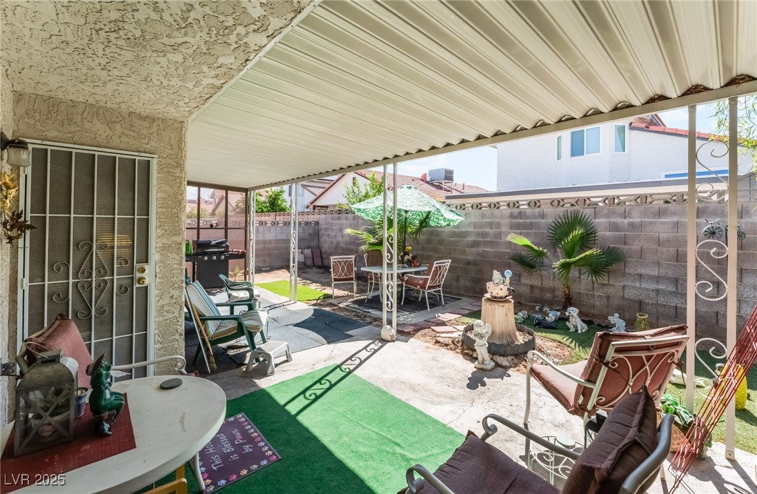 6513 Deadwood Road Las Vegas, NV 89108 - Photo 30 of 34 Fenced backyard featuring a patio area, area for grilling, and outdoor dining space