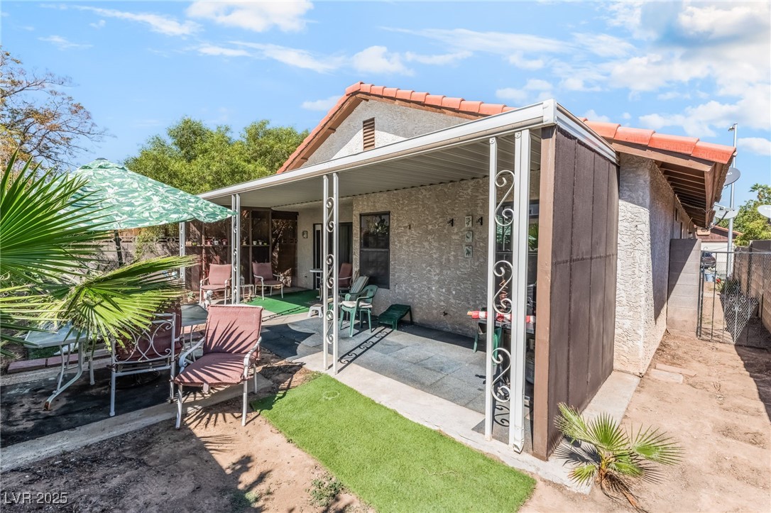 6513 Deadwood Road Las Vegas, NV 89108 - Photo 32 of 34 Back of house featuring a patio area, stucco siding, and a tile roof