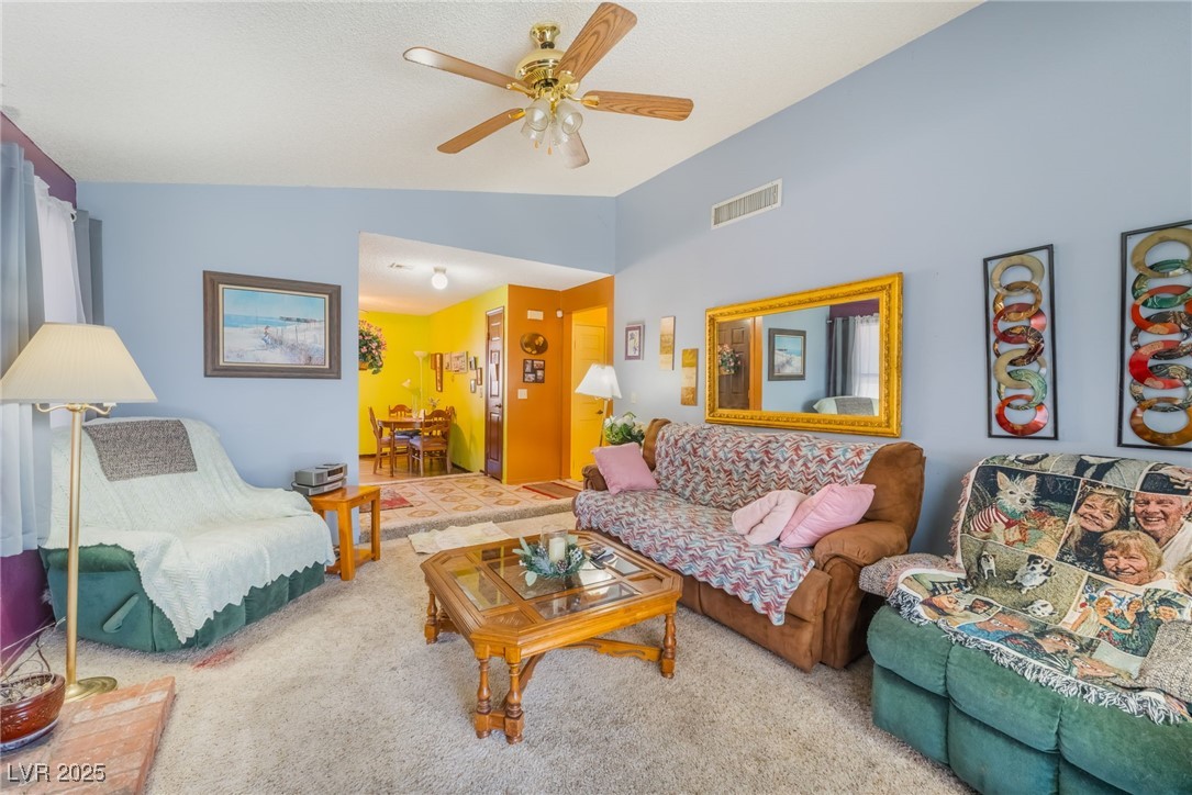 6513 Deadwood Road Las Vegas, NV 89108 - Photo 10 of 34 Carpeted living area with lofted ceiling and a ceiling fan