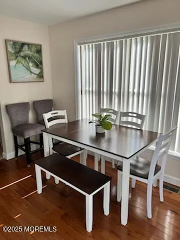 a room with furniture pool table and windows