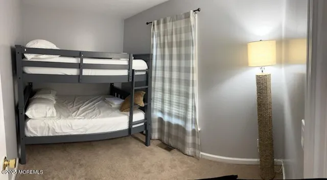 a bedroom with a bed and lamp