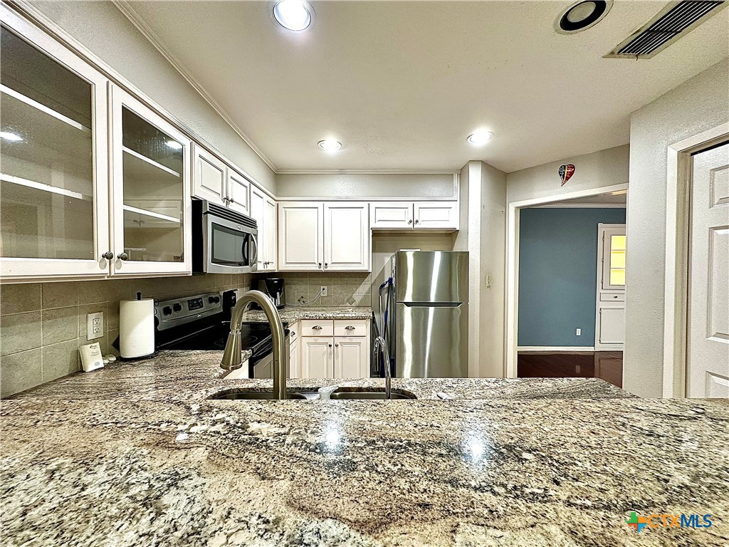 120 Andover Street Victoria, TX 77904 - Photo 20 of 40 a kitchen with a refrigerator sink and cabinets
