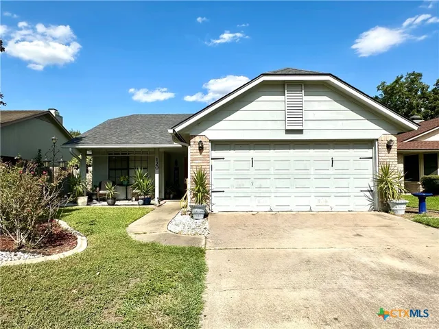 a front view of a house with a yard and porch