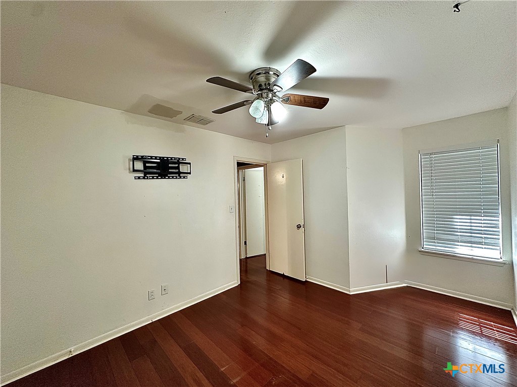 120 Andover Street Victoria, TX 77904 - Photo 33 of 40 a view of an empty room with window and wooden floor