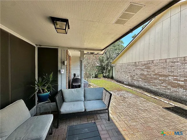 a balcony with furniture and a potted plant
