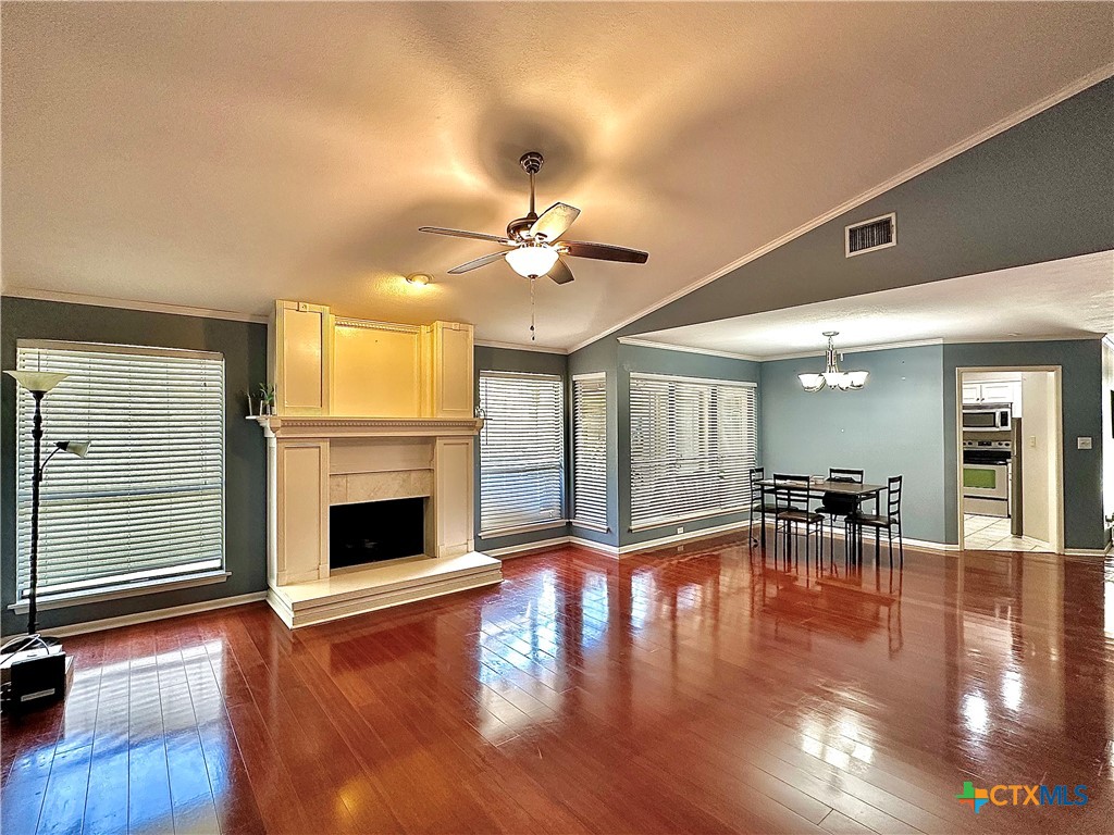 120 Andover Street Victoria, TX 77904 - Photo 7 of 40 a view of a livingroom with a ceiling fan fireplace and wooden floor