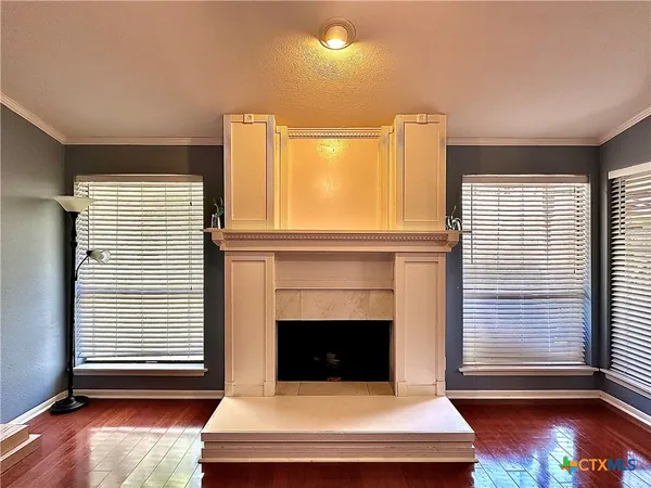 a living room with furniture fireplace and window