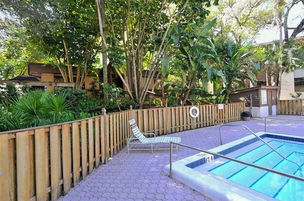 a view of backyard with a table and chairs under an umbrella