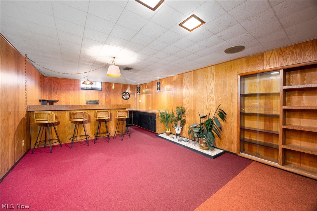 364 Mowbray Road Akron, OH 44333 - Photo 29 of 44 Rec room bar featuring decorative light fixtures, wood finish cabinetry, and wooden walls