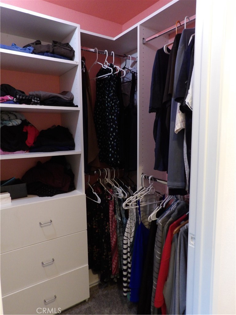 19140 Lahey Street, Unit 4 Porter Ranch, CA 91326 - Photo 11 of 37 a view of walk in closet with clothes and shoes