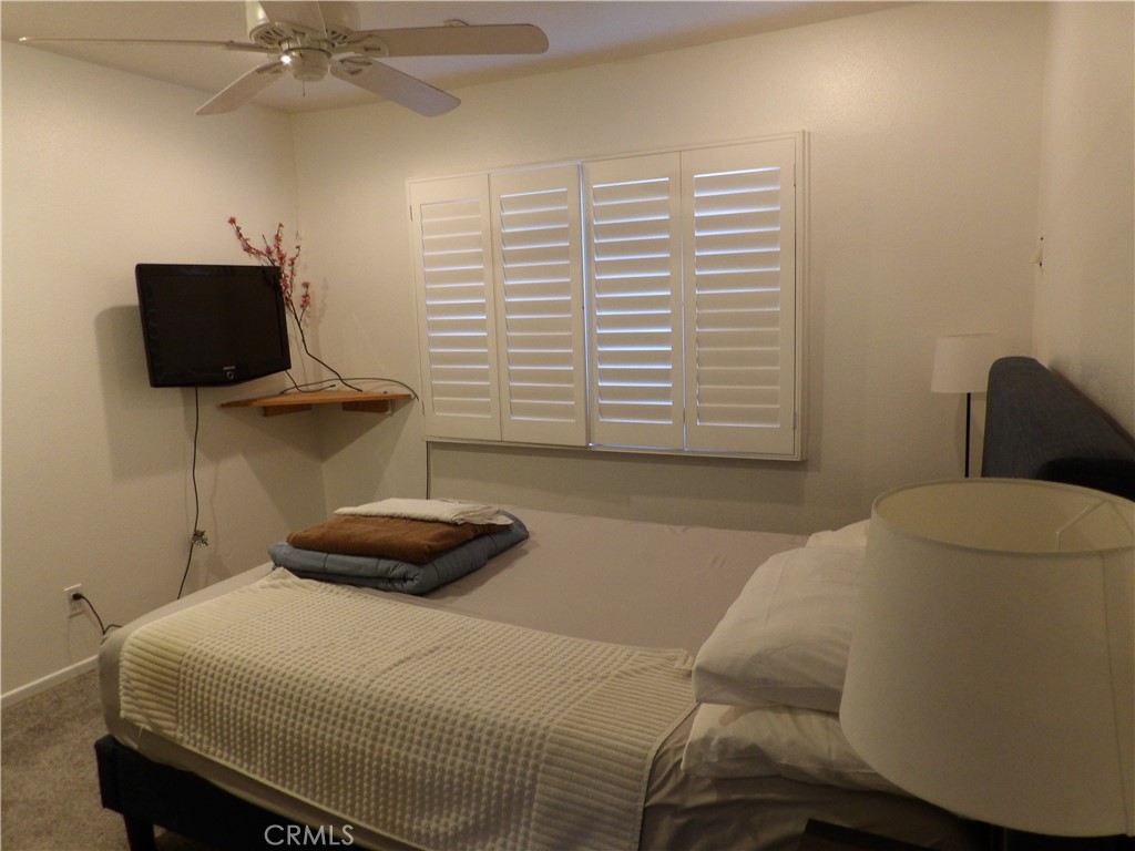 19140 Lahey Street, Unit 4 Porter Ranch, CA 91326 - Photo 14 of 37 a bedroom with a bed and a chair
