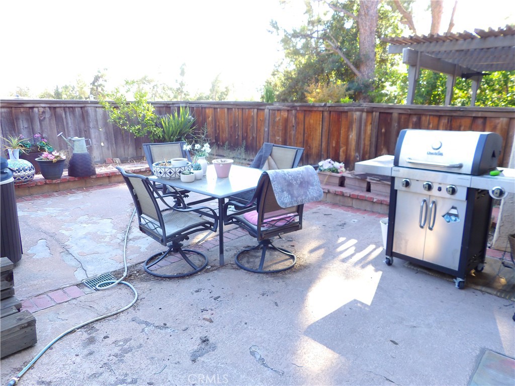 19140 Lahey Street, Unit 4 Porter Ranch, CA 91326 - Photo 22 of 37 a view of a chairs and table in the back yard