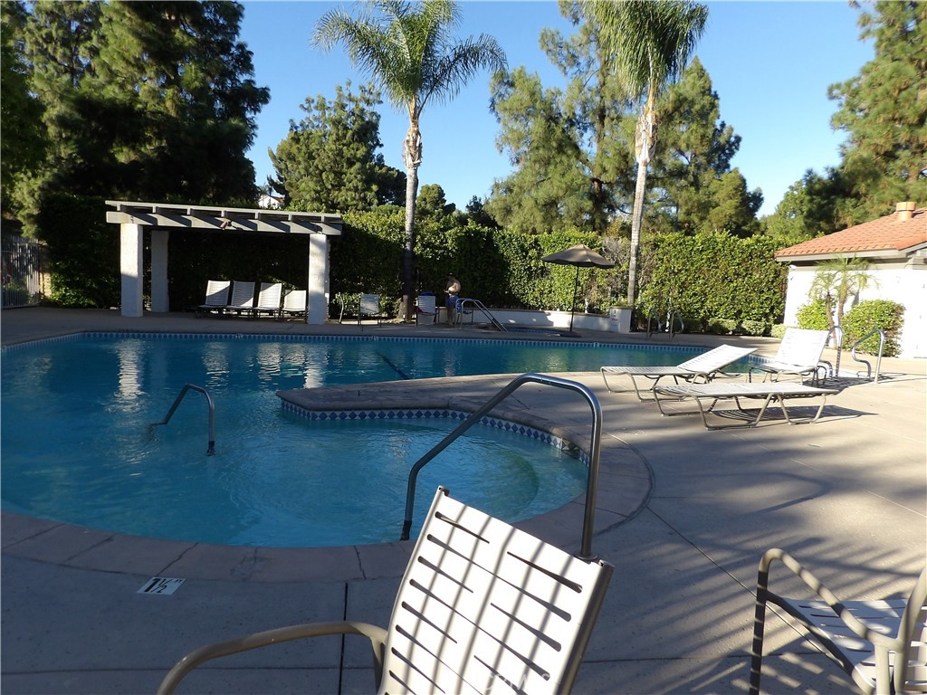19140 Lahey Street, Unit 4 Porter Ranch, CA 91326 - Photo 28 of 37 a view of a swimming pool with a patio