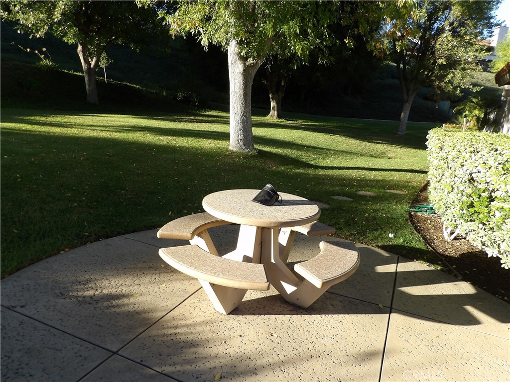 19140 Lahey Street, Unit 4 Porter Ranch, CA 91326 - Photo 33 of 37 a swimming pool with some trees in the background